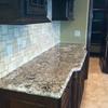 Delicatus White Countertops with Mosaic Travertine Backsplash 